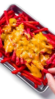 a person holding a tray with some food on it