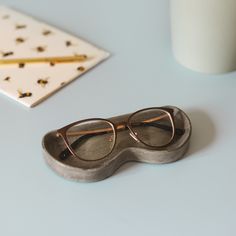 a pair of glasses sitting on top of a table