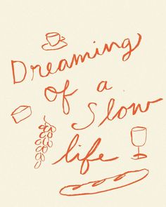 the words dreaming of a slow life are drawn in red ink on a white paper