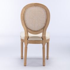 a chair made out of wood with a white back and beige upholstered seat