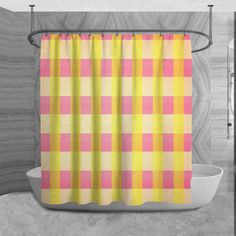 a yellow and pink shower curtain hanging on a bathroom wall next to a bathtub