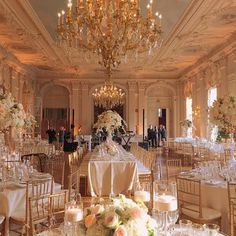 an elegant ballroom with chandeliers and tables set for formal dinner or wedding reception