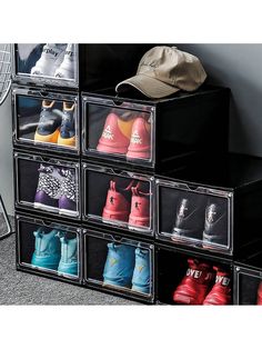 a stack of six clear storage bins filled with different pairs of shoes and hats