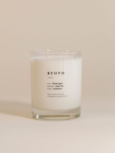 a white candle sitting on top of a table