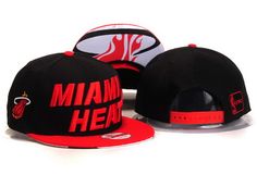 three miami heat hats on display against a white background