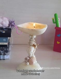 Seashells have been glued together to form a candlestick that holds a tealight candle. The base and the top that holds the candle are clamshells, and the middle is made of various other shells and some pearls. Sea Glass Interior Design, Clay Sculpture Air Dry, Seashell Projects Diy Beach Crafts, Mermaidcore Bedroom, Mermaidcore Decor, Shell Crafts Seashells Diy Ideas, Sea Shell Crafts Seashell Art, What To Do With Sea Shells