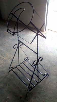 a metal rack that has some type of object on it's back legs and is leaning up against the wall