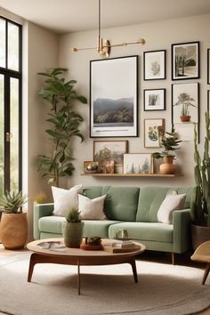 Modern living room with a green sofa, large plants, and a gallery wall of nature-themed artwork.