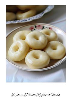 there are several donuts on the plate and one is in front of another bowl