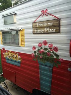 an old trailer is decorated with flowers and the words, this is my happy place