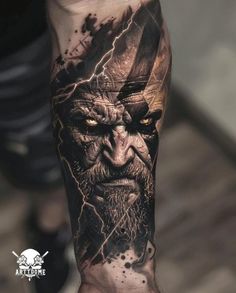 a man's arm with an evil face and lightning coming out of his eyes