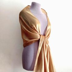 A magnificent organza shawl with a rough effect. Beautiful beige color with a precious golden shine. The golden beige shawl or bolero is made of high-quality organza with a beautiful shine. Evening cape and shawl for the mother of the bride, bridesmaids. It will gently cover your shoulders on a summer evening or in the spring. Length approximately 200 cm Width approximately 48 cm Color rendering may differ depending on monitor settings. Due to the sensitive nature of the veiled item this is a final sale and cannot be returned, but if you have any questions please contact me and I will resolve the issues. Luxury Gold Shawl For Eid, Elegant Gold Scarf For Evening, Elegant Gold Scarf For Wedding, Elegant Gold Silk Scarf For Evening, Elegant Gold Pashmina Shawl, Formal Gold Silk Scarf, Elegant Gold Scarves For Formal Occasions, Elegant Gold Formal Scarves, Elegant Gold Silk Scarf