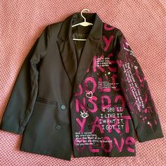 a black jacket with pink and purple designs on it