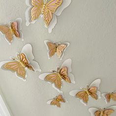 the butterflies are hanging from the ceiling in the room, and they look like they have been painted gold