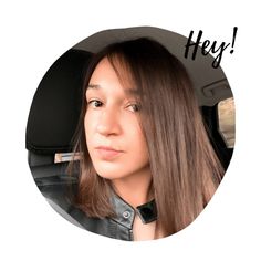 a woman with long hair sitting in a car