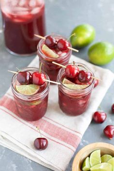 three jars filled with cherries and limes