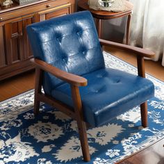 a blue chair sitting on top of a rug