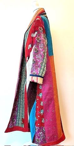 This Patchwork Blanket Coat encapsulate the essence of diversity, embodying the rich tapestry of cultures and traditions that form the cornerstone of their design. No two coats are alike. The careful selection and arrangement of the vintage fabrics ensure that every creation stands as an individual work of art, telling its own compelling story. Colorful Kantha stitching on triple layers of cotton. Heavy and warm. Kantha Stitching on the mixed print with the reverse side, neutral pin stripe. This jacket is fully reversible; offering two varied prints. Great value. Owning a Premium Patchwork Blanket Coat transcends mere fashion; it's an invitation to be part of a narrative, a journey through time and tradition. It’s an ode to individuality, a celebration of the extraordinary within the ordin Blanket Coats, Patchwork Coat, Patchwork Blanket, Blanket Coat, Pin Stripe, Vintage Fabrics, British Indian, The Vintage, Cover Up