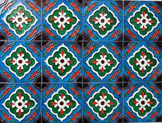 an artistic tile design in blue, green and red