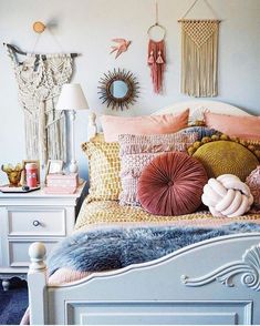 a white bed topped with lots of pillows