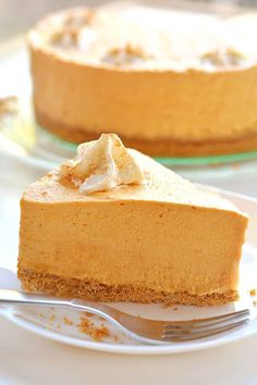 a slice of pumpkin cheesecake on a plate with a fork in front of it