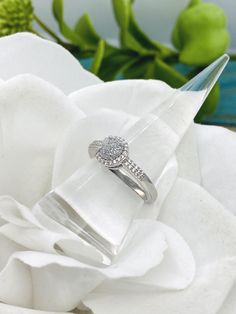 This beautiful sterling silver round bezel ring will be created with cremation ashes. The cremation "stone" measures approximately 6.5mm and this band's width is approximately 2.4mm wide. The ring is semi-mounted with 20 round CZs in shared-prong settings in double rows along the shoulders, and 21 round CZs set in the halo that encircles the center mounting. Available in sizes 6,7, and 8. *All the pieces in my cremation collection have a finished look that resemble glass or stone once set. I do make these pieces with the ashes visible, however you can specify in a note to me if you would prefer not to see the ashes. I take great care in creating these special keepsakes and I can assure you that all cremains/ashes will be handled with dignity.***Process***Ashes are delicately and precisely Silver Stackable Rings With Center Stone, Round Cut, Diamond White Halo Ring For Promise With Round Stone, Silver Stackable Rings With Halo Setting For Anniversary, Silver Cluster Ring With Bezel Setting For Anniversary, Silver Birthstone Ring With Halo And Round Cut, Silver Anniversary Ring With Halo Design, Promise Ring With Round Halo Stone, Promise Rings With Halo Setting, Silver Cubic Zirconia Stackable Rings With Halo