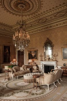 an ornate living room with chandelier, couches and chairs in it's center