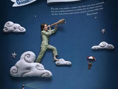 an advertisement for goodies featuring a man with a telescope in the sky and clouds