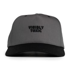 a grey and black hat with the words visible on it