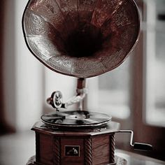 an old fashioned record player sitting on top of a table