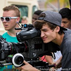 a man holding a camera in front of other people