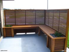 a wooden bench sitting next to a planter