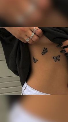 a woman's stomach with butterflies on her side and the bottom part of her belly