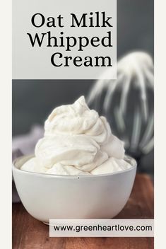 a bowl filled with whipped cream on top of a wooden table