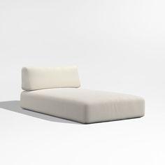 a white couch sitting on top of a white floor