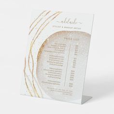 a price list with gold glitters on the front and back of an acrylic sign