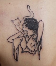 a woman with a cat on her back tattooing it's chest and shoulder