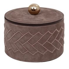 a round box with a metal ball on top of it and an intricate design around the lid