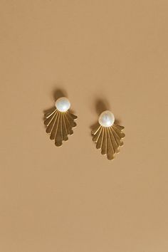 two pairs of gold earrings with pearls on the bottom and one pearl in the middle