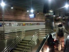 an escalator in a subway station with people on it