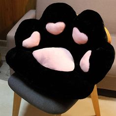 a black chair with pink hearts on it's face and eyes in the shape of a cat