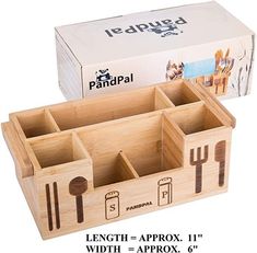 a wooden utensil holder with forks and spoons in it next to a cardboard box