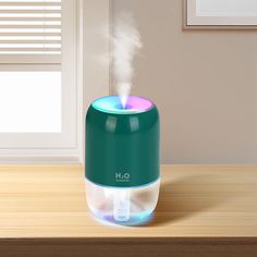 a humidifier sitting on top of a wooden table