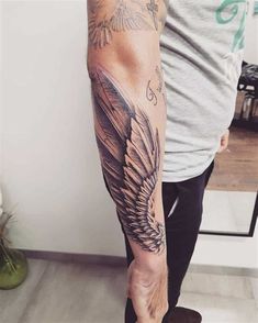 a man's arm with an eagle tattoo on it