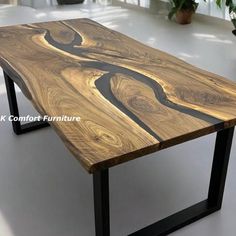 a wooden table with black metal legs and a wood slab on the top that is shaped like a river