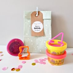 the contents of an ice cream cup are displayed on a white table with confetti sprinkles