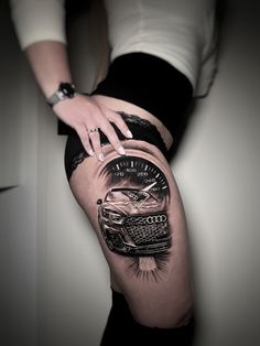 a woman's thigh with a car on it and a speedometer in the middle