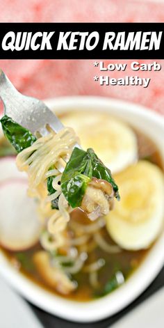 a close up of a spoon full of soup with noodles and spinach on it