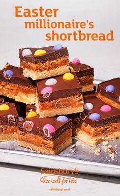 there are many pieces of shortbread on the plate with chocolate frosting and candies