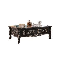 an ornately decorated coffee table with drawers and trays on it's sides